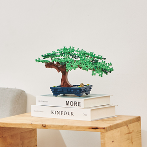 LEGO bonsai staged on nice books and wooden table 